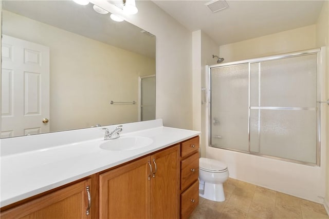 full bathroom featuring shower / bath combination with glass door, vanity, and toilet