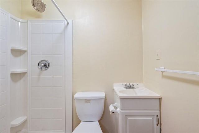 bathroom featuring a shower, vanity, and toilet