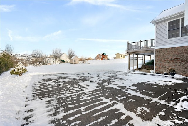 snowy yard with a balcony