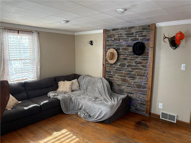 living room with hardwood / wood-style flooring and ornamental molding