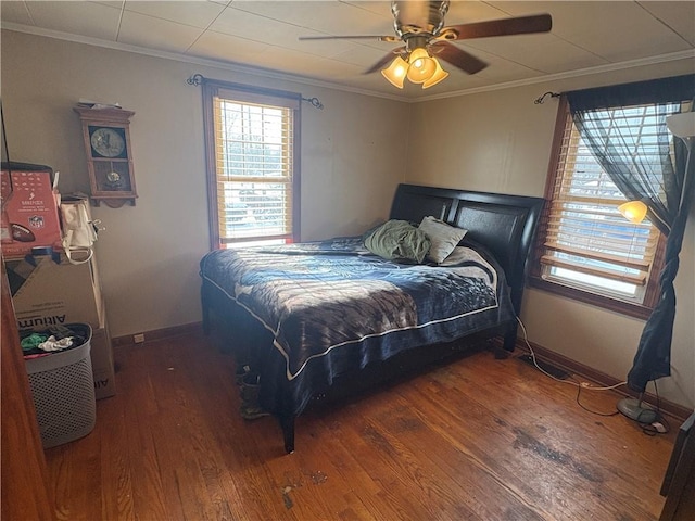 bedroom featuring ceiling fan, ornamental molding, and dark hardwood / wood-style flooring