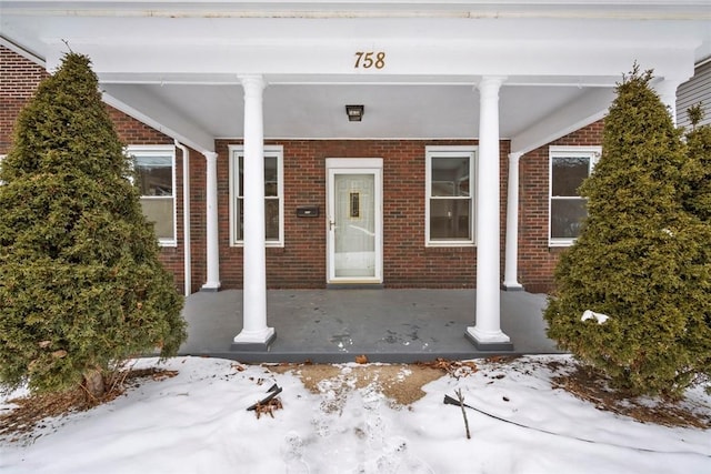 view of snow covered property entrance