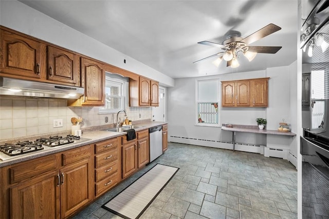 kitchen featuring decorative backsplash, ceiling fan, sink, and appliances with stainless steel finishes