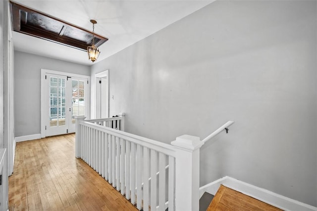 corridor with light hardwood / wood-style floors