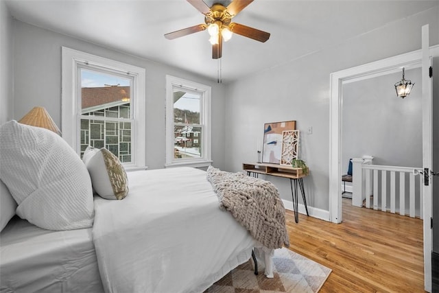 bedroom with light hardwood / wood-style floors and ceiling fan