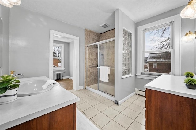 bathroom with a wealth of natural light, vanity, a baseboard heating unit, radiator heating unit, and a shower with shower door