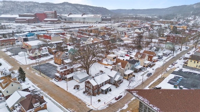 snowy aerial view featuring a mountain view