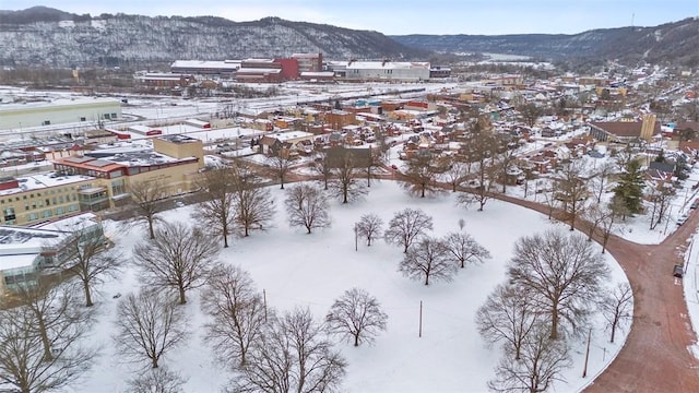 snowy aerial view featuring a mountain view