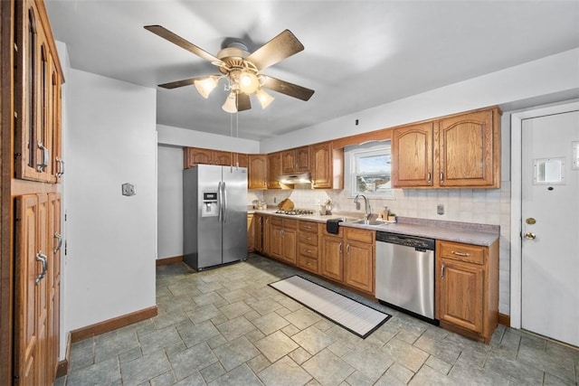 kitchen featuring backsplash, ceiling fan, sink, and stainless steel appliances