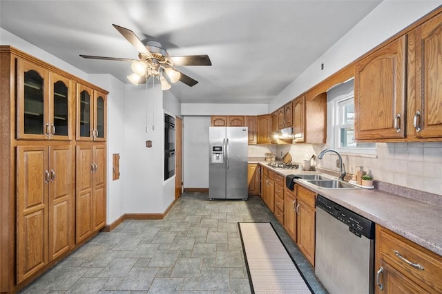 kitchen featuring appliances with stainless steel finishes, tasteful backsplash, ceiling fan, and sink