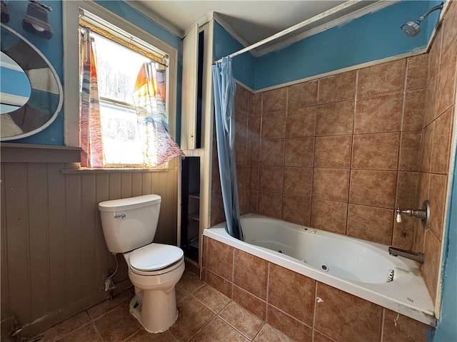 bathroom featuring tile patterned floors, toilet, and shower / bath combo with shower curtain