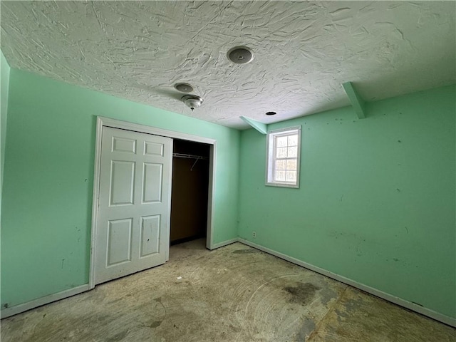 unfurnished bedroom with a closet and a textured ceiling