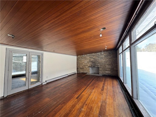 unfurnished living room featuring hardwood / wood-style floors, baseboard heating, lofted ceiling, and wood ceiling