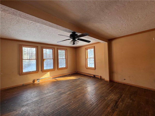 empty room with baseboard heating, a wealth of natural light, ceiling fan, and wood-type flooring