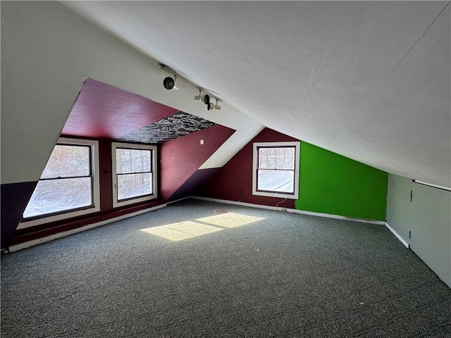 bonus room featuring carpet flooring and lofted ceiling