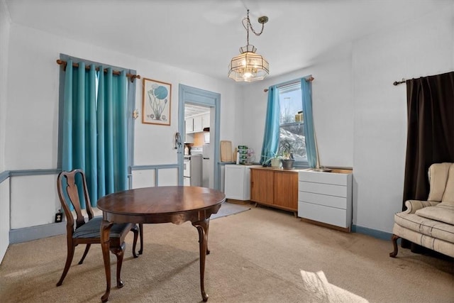 dining area featuring light colored carpet