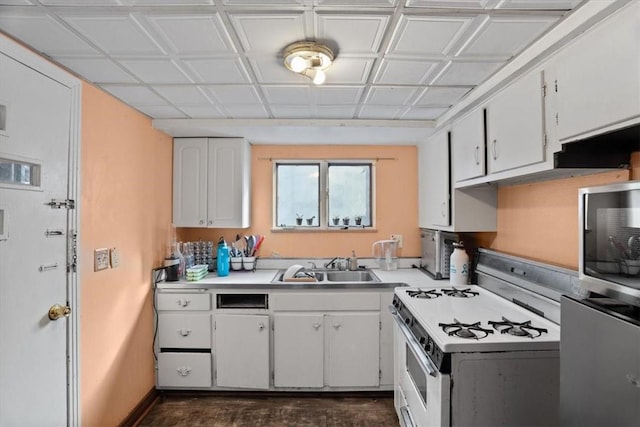 kitchen featuring white cabinetry, sink, and white range with gas stovetop