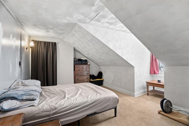 bedroom featuring light carpet and vaulted ceiling