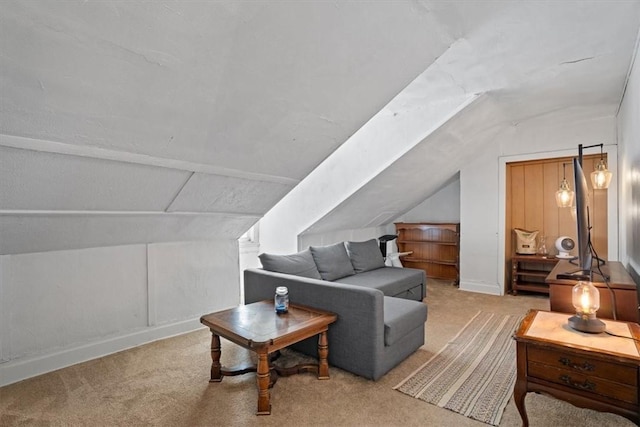 carpeted living room with lofted ceiling