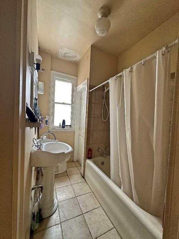 bathroom featuring shower / tub combo and tile patterned floors