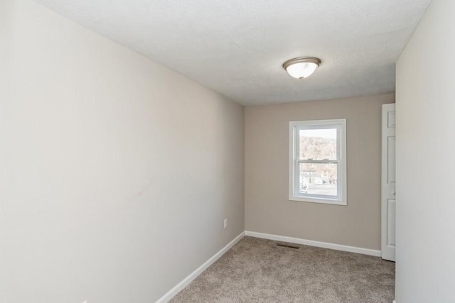 unfurnished room with light carpet