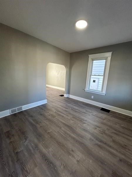 spare room featuring dark wood-type flooring