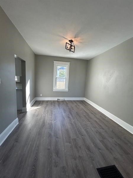 unfurnished room with dark hardwood / wood-style floors