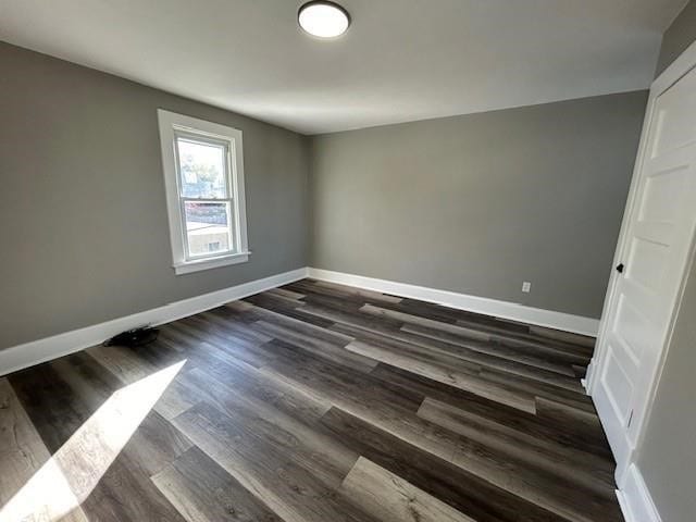 unfurnished room with dark hardwood / wood-style floors