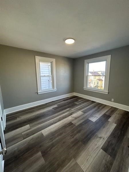 unfurnished room with dark wood-type flooring