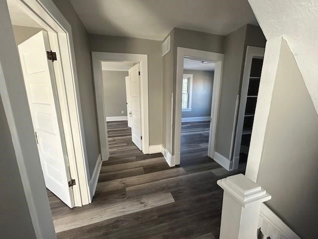 corridor with dark wood-type flooring