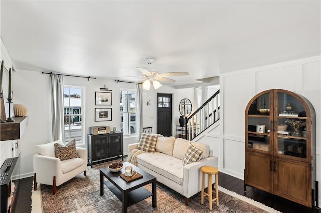 living room with dark hardwood / wood-style floors and ceiling fan