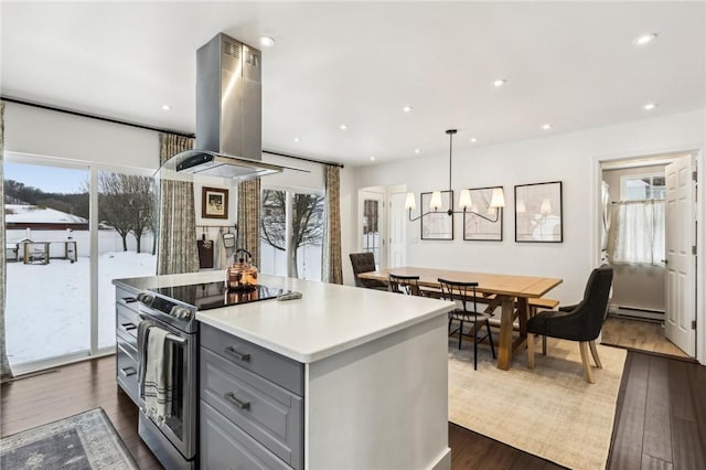 kitchen with baseboard heating, island exhaust hood, decorative light fixtures, gray cabinets, and stainless steel range with electric cooktop