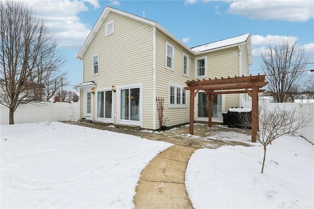 snow covered property with a pergola