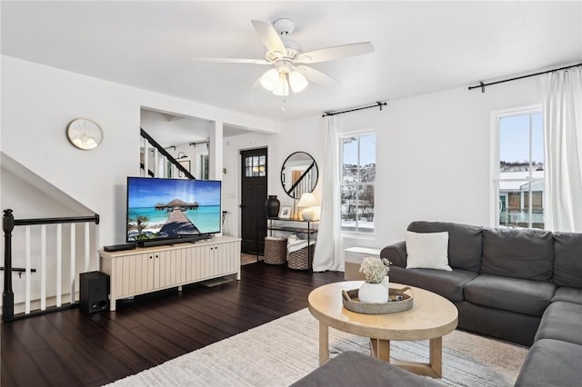 living room featuring dark hardwood / wood-style floors and ceiling fan