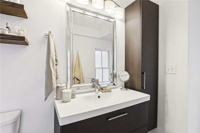 bathroom featuring vanity and toilet