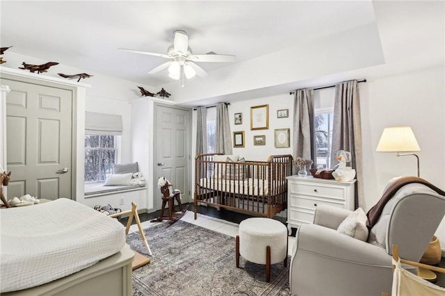 bedroom featuring multiple windows and ceiling fan