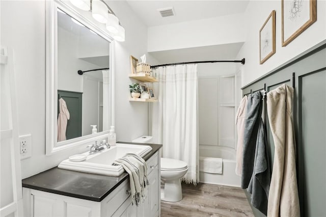 full bathroom featuring shower / bath combo, toilet, wood-type flooring, and vanity