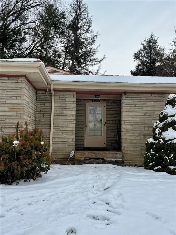 view of snow covered property entrance