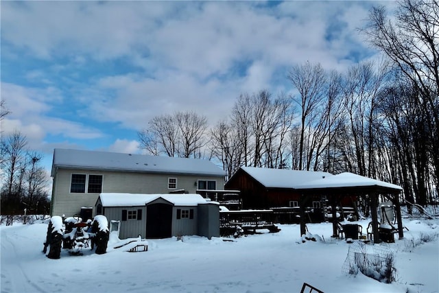 view of snow covered back of property