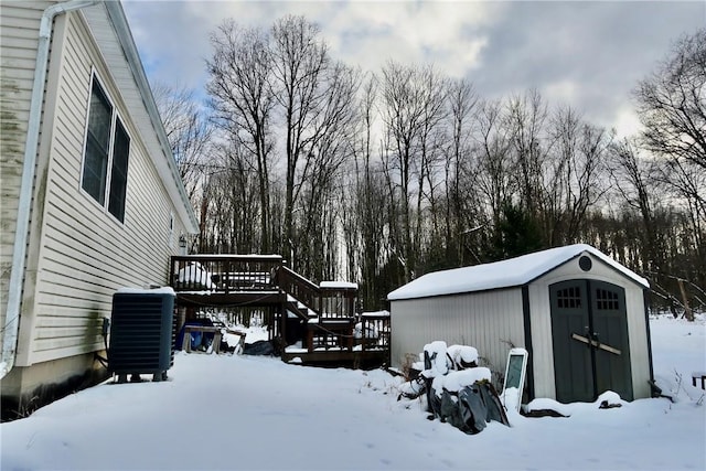 exterior space with central AC, a shed, and a deck