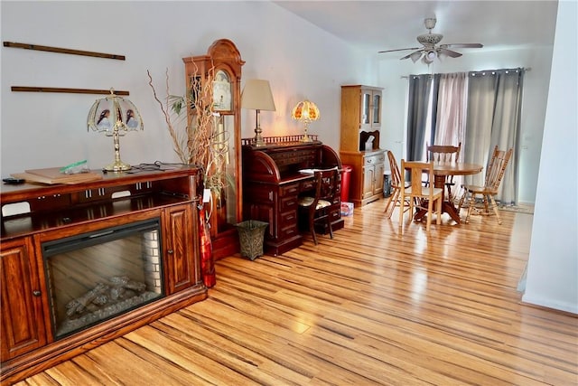 living area with light hardwood / wood-style flooring and ceiling fan