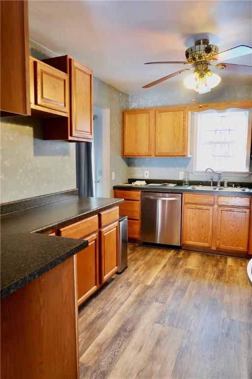 kitchen with ceiling fan, dishwasher, sink, and light hardwood / wood-style flooring