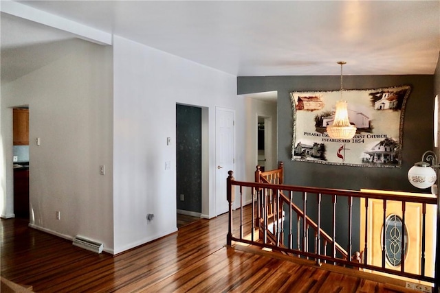 hall featuring wood-type flooring and a notable chandelier