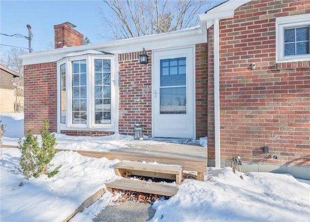 view of snow covered property entrance