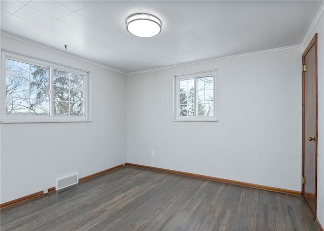 interior space featuring wood finished floors, visible vents, crown molding, and baseboards