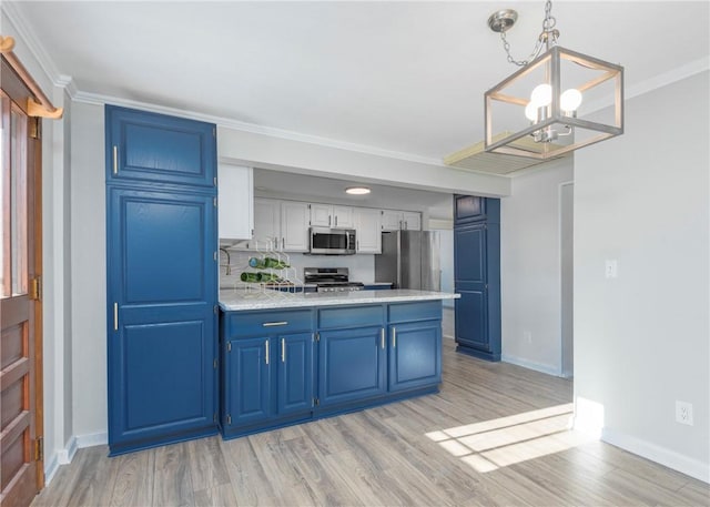 kitchen with white cabinetry, hanging light fixtures, light hardwood / wood-style flooring, blue cabinets, and appliances with stainless steel finishes