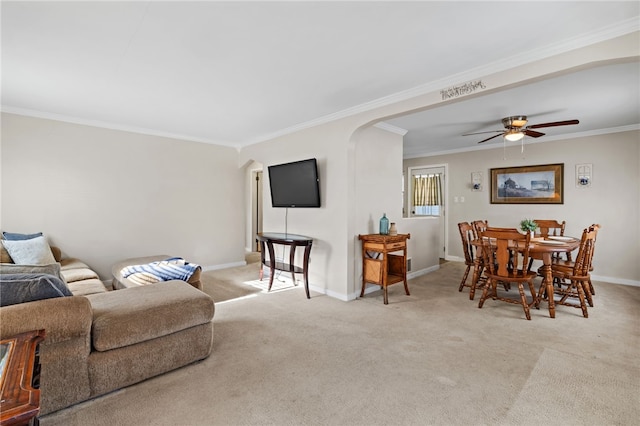 carpeted living room featuring ceiling fan and crown molding