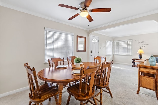 carpeted dining area featuring ceiling fan and ornamental molding