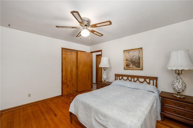 bedroom with wood-type flooring, a closet, and ceiling fan