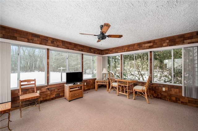 sunroom featuring a wealth of natural light and ceiling fan